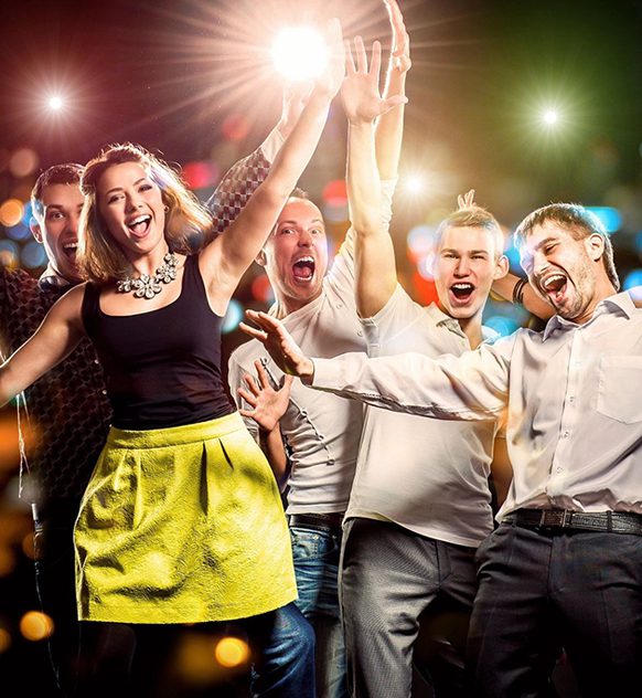 Cheerful group of young people dancing at party